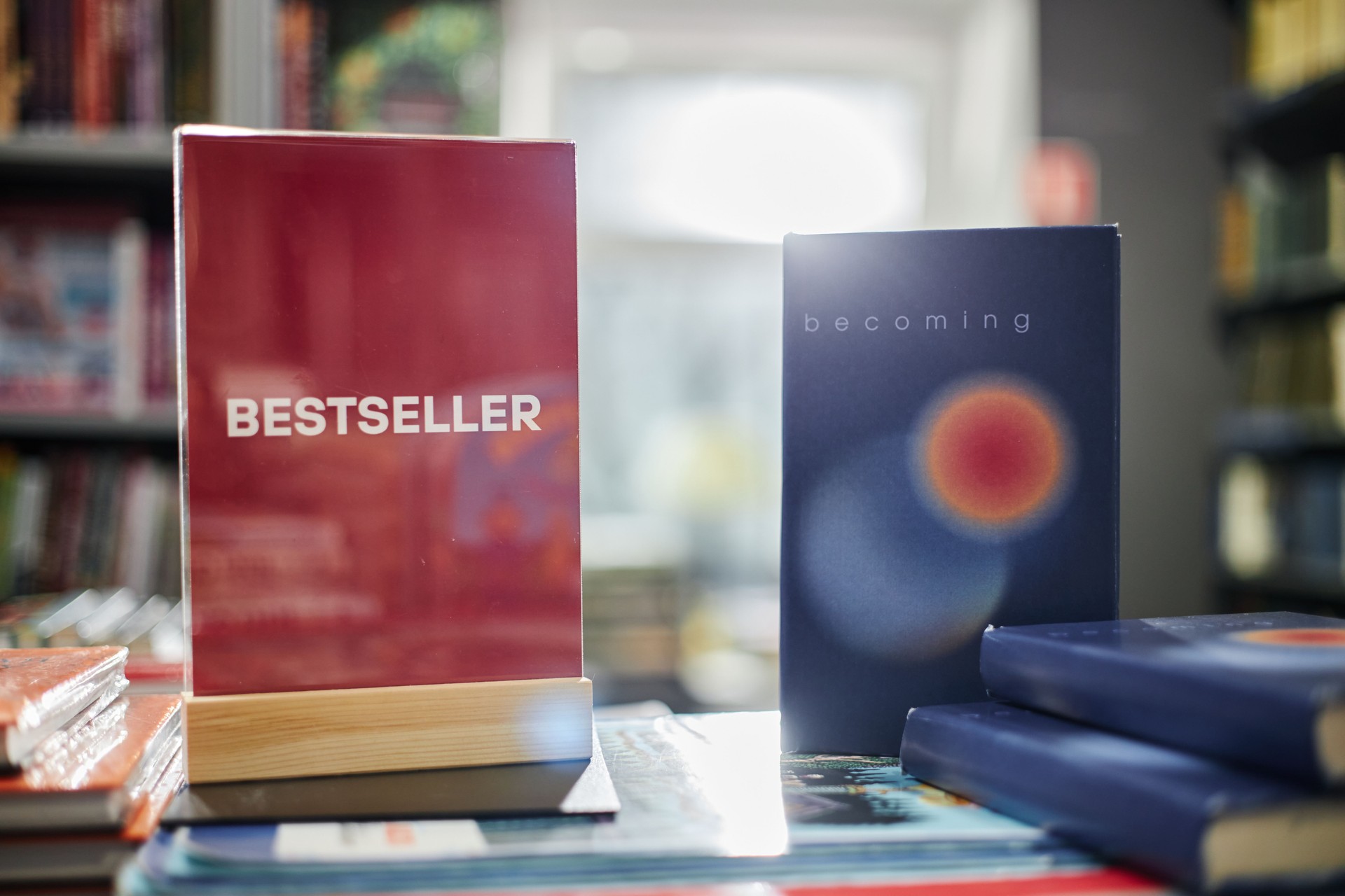 Hardcover Novels Arranged on Table in Bookstore under Natural Lighting